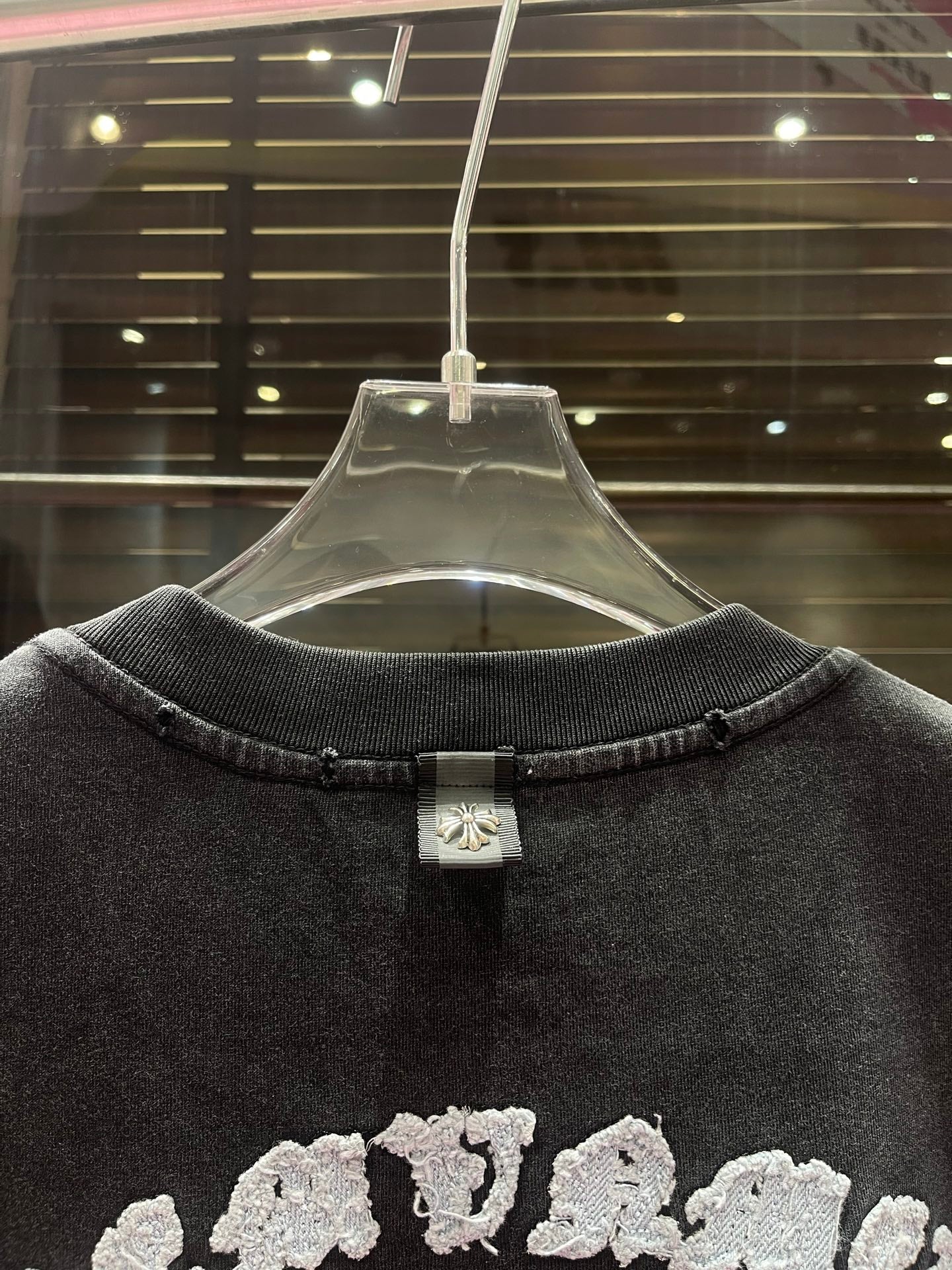 Dark charcoal crewneck T-shirt back view with neck tag detail