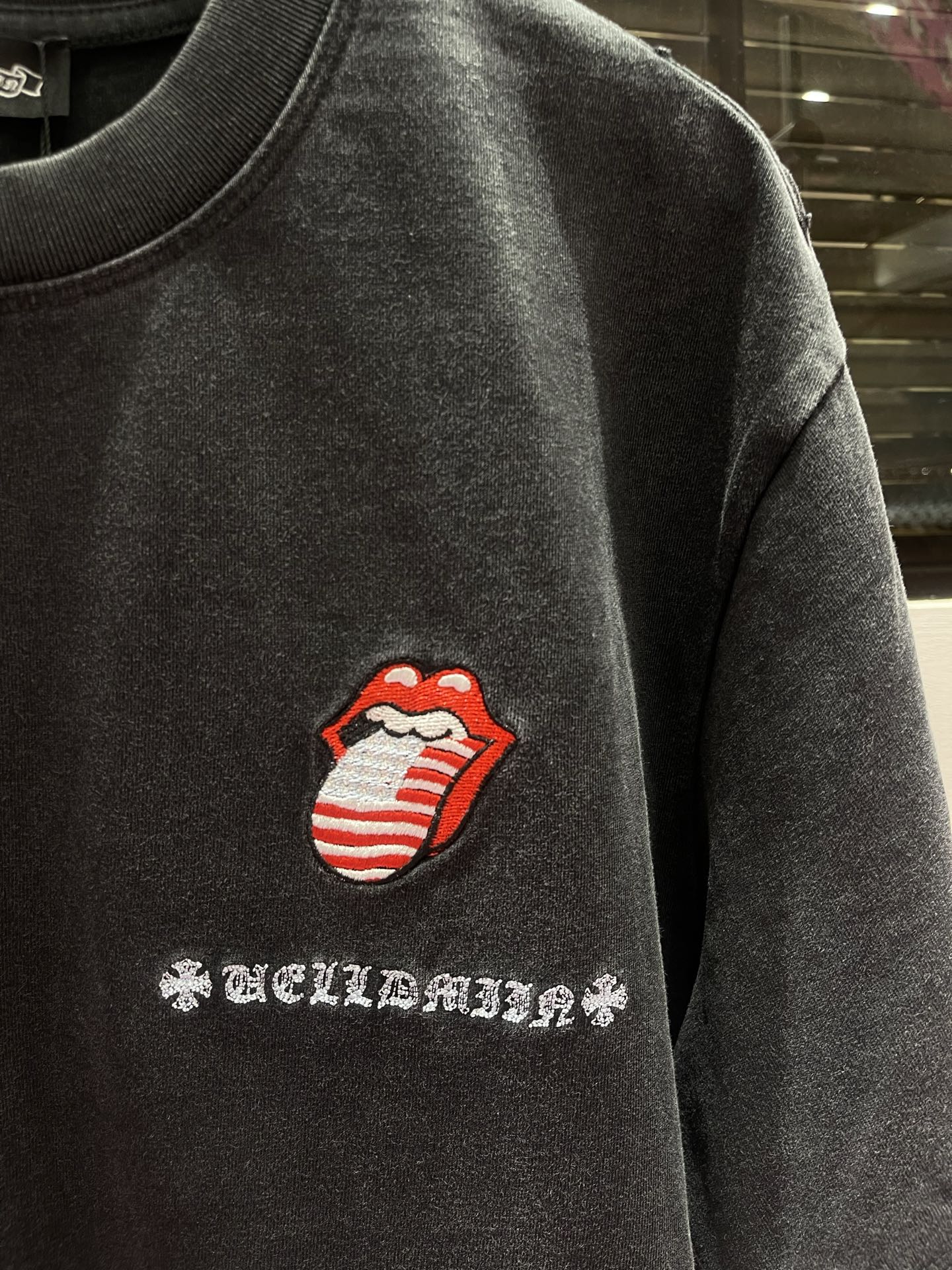 Dark charcoal T-shirt with red-and-white lips graphic and decorative chest text