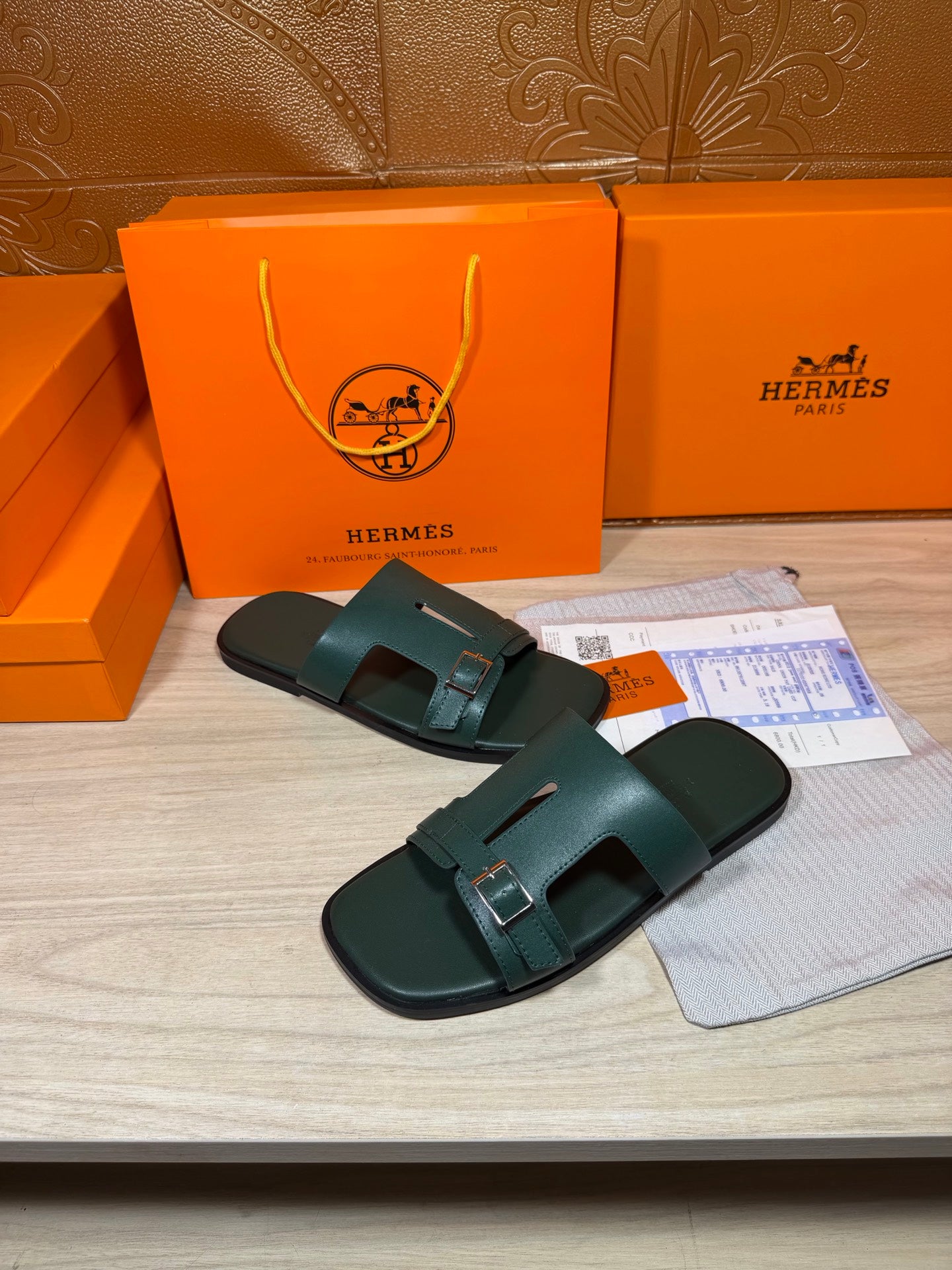 Hermes teal-green slide sandals with two buckled straps and molded footbed