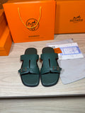 Hermes teal-green leather slide sandals with two adjustable buckle straps and open toe