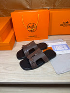 Brown leather slide sandals with wide double straps and silver buckles