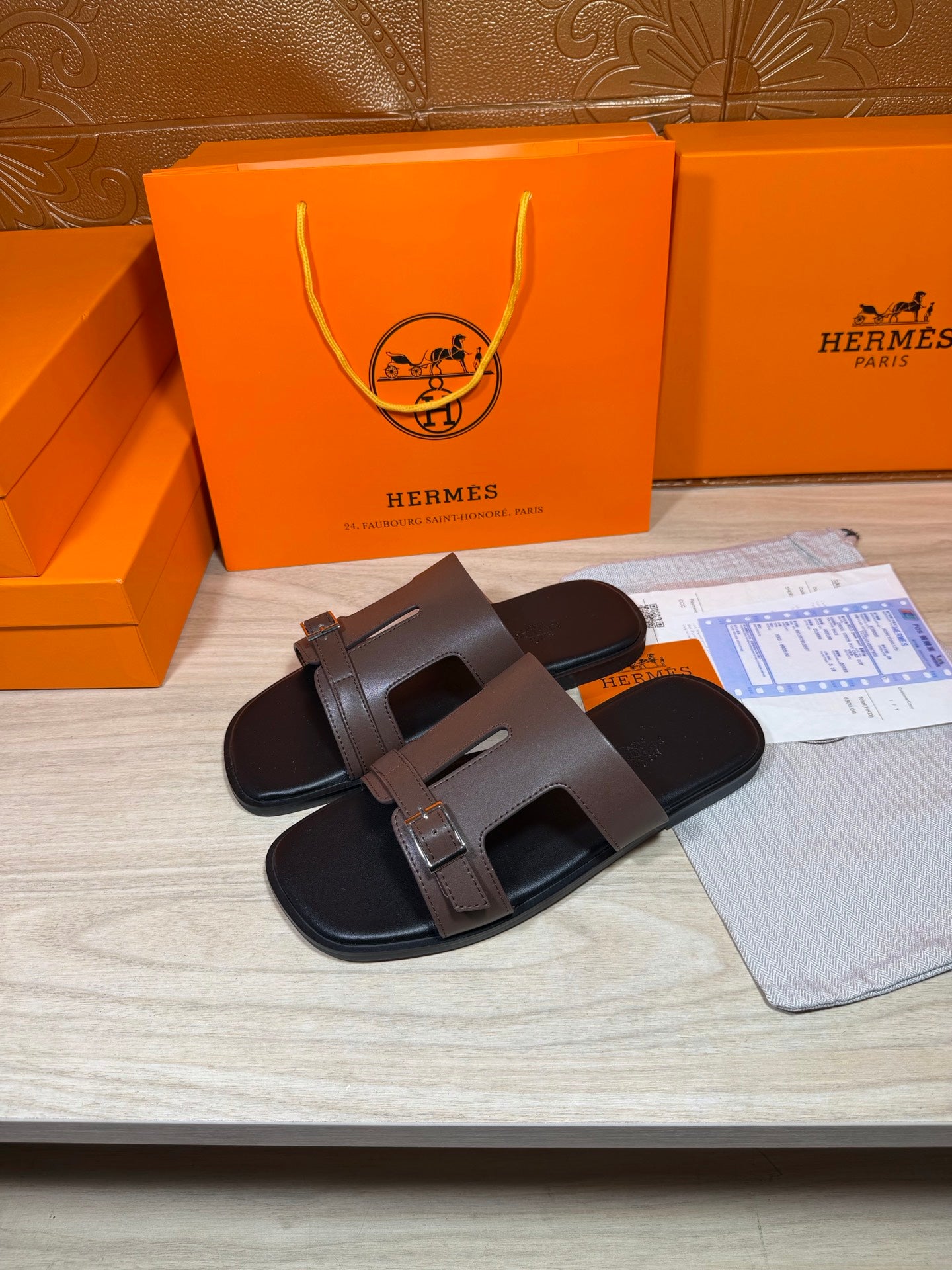 Brown leather slide sandals with wide double straps and silver buckles