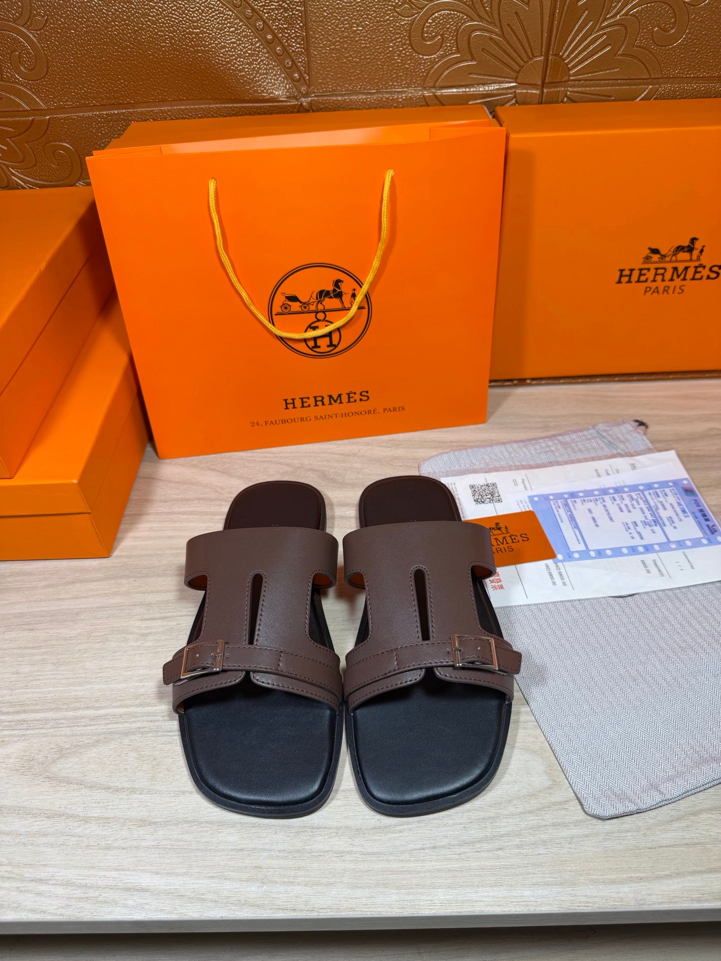 Brown leather slide sandals with two adjustable buckled straps