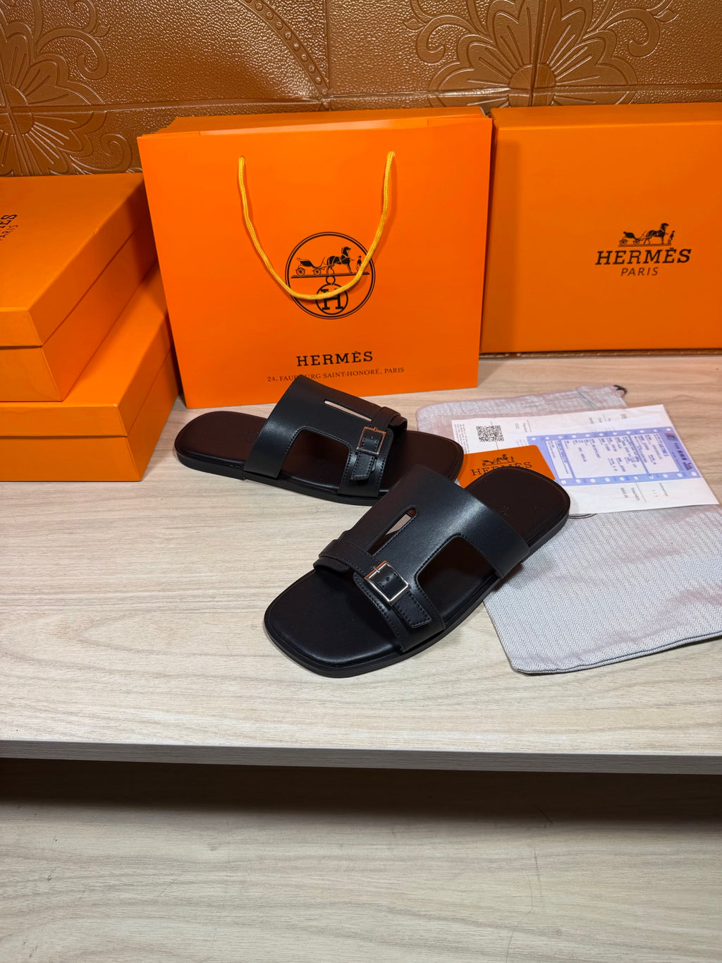 Black slide sandals with double buckles and wide padded straps