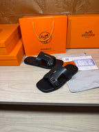 Black slide sandals with double buckles and wide padded straps