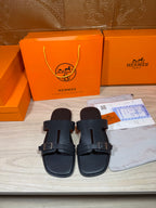 Black slide sandals with two buckle straps and cushioned footbed