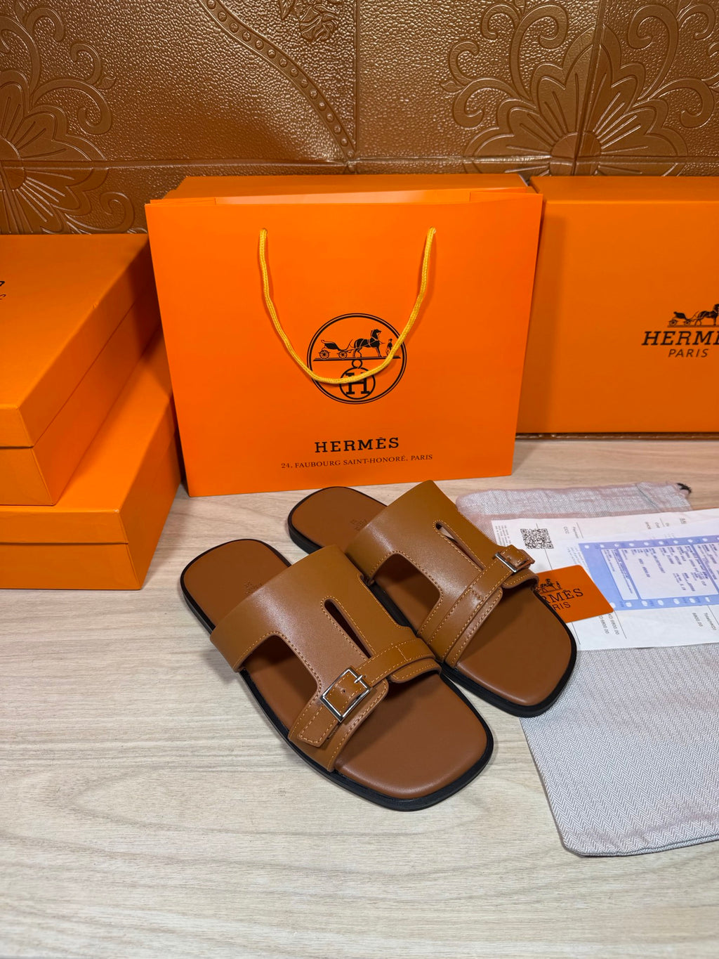 Hermes tan leather sandals with single-bar buckle strap design, side view.