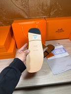 Hermes tan sandal outsole with size label and embossed logo, heel side.