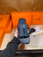 Hermes blue slide sandal close-up, front strap with silver buckle over footbed