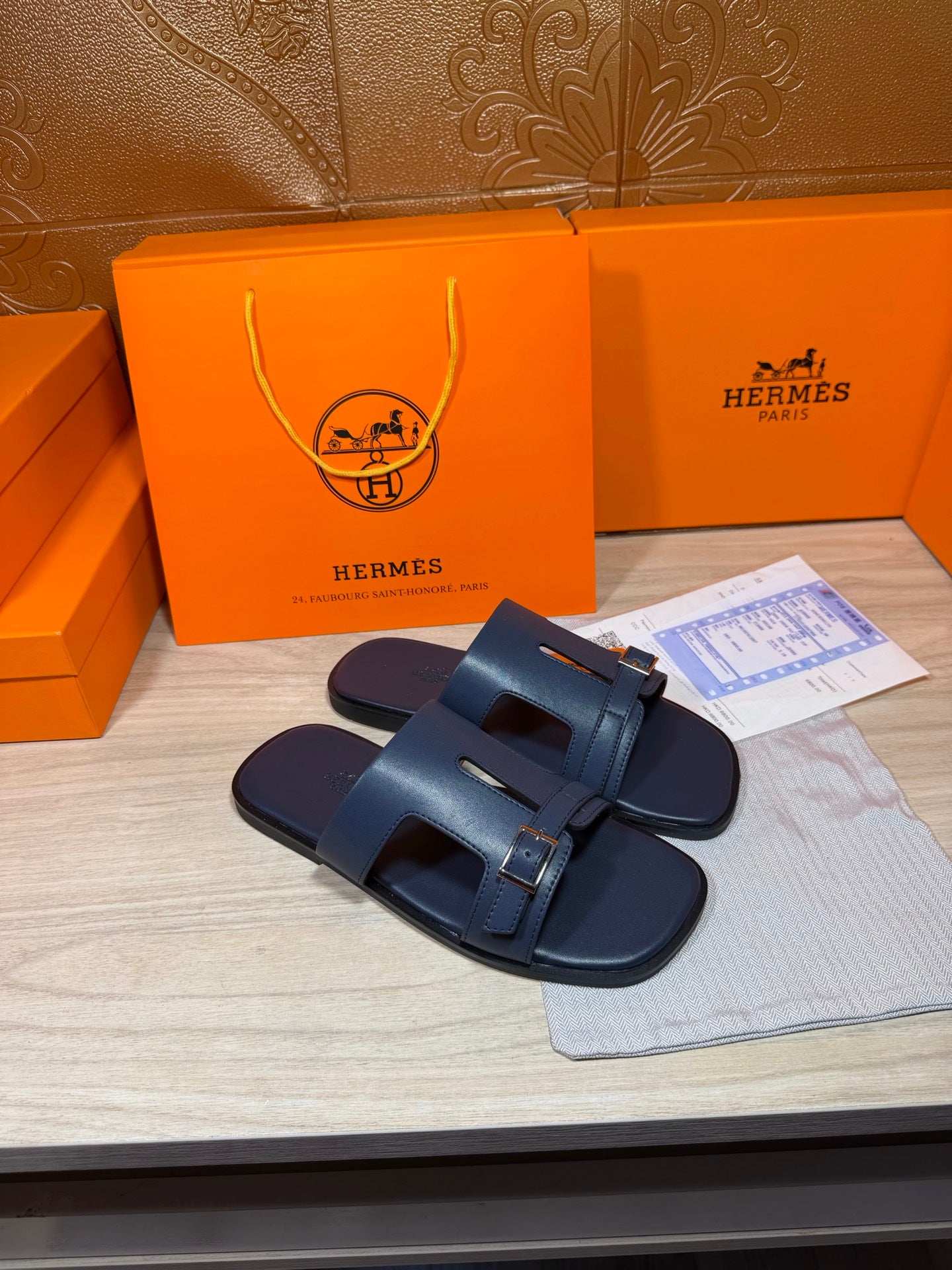 Hermes blue leather slide sandals with wide front strap and silver buckle detail