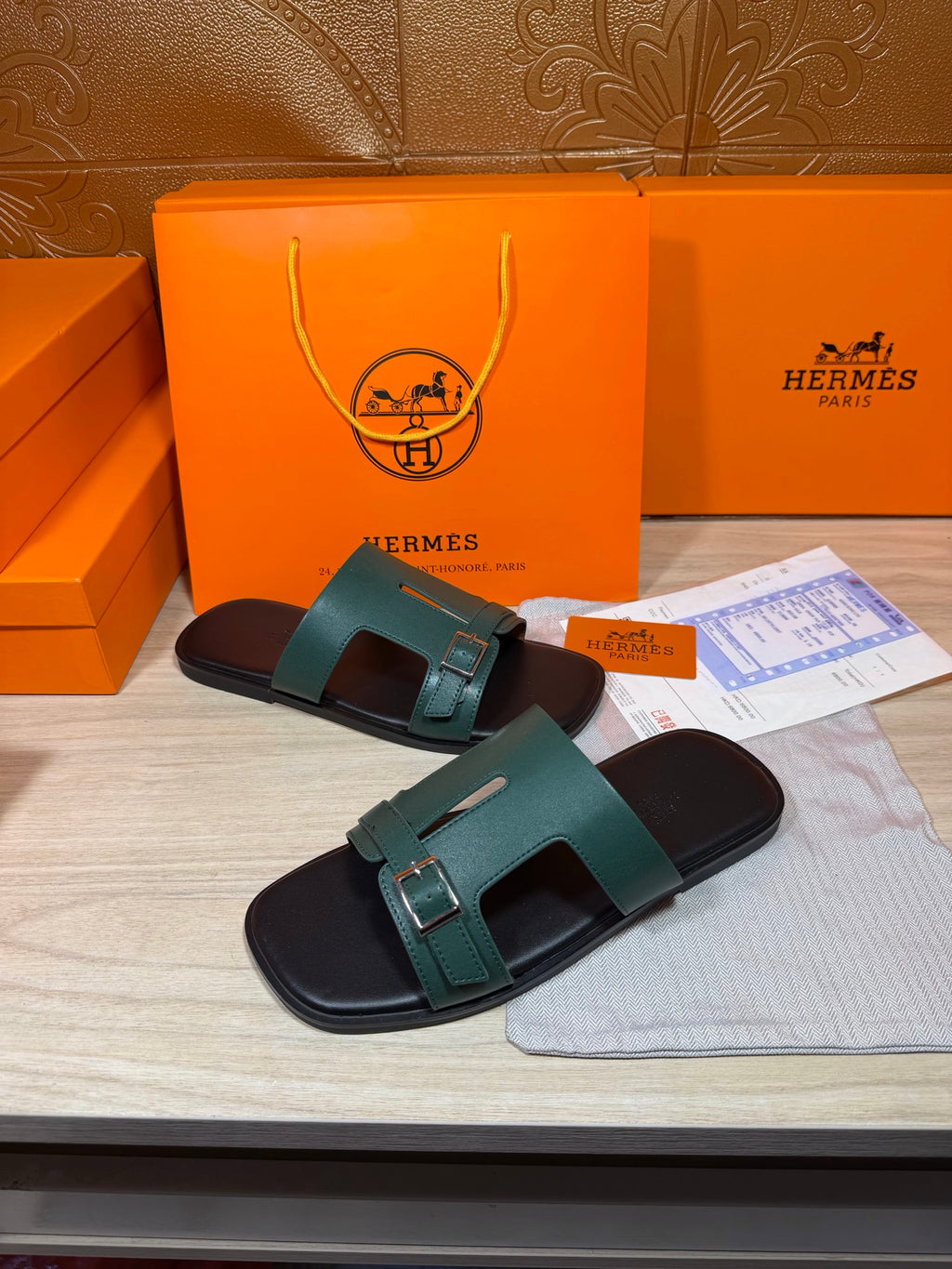 Hermes sandals with teal two-strap design and silver buckle over black base