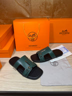 Hermes sandals, two teal slide sandals on black footbeds with metal buckle details