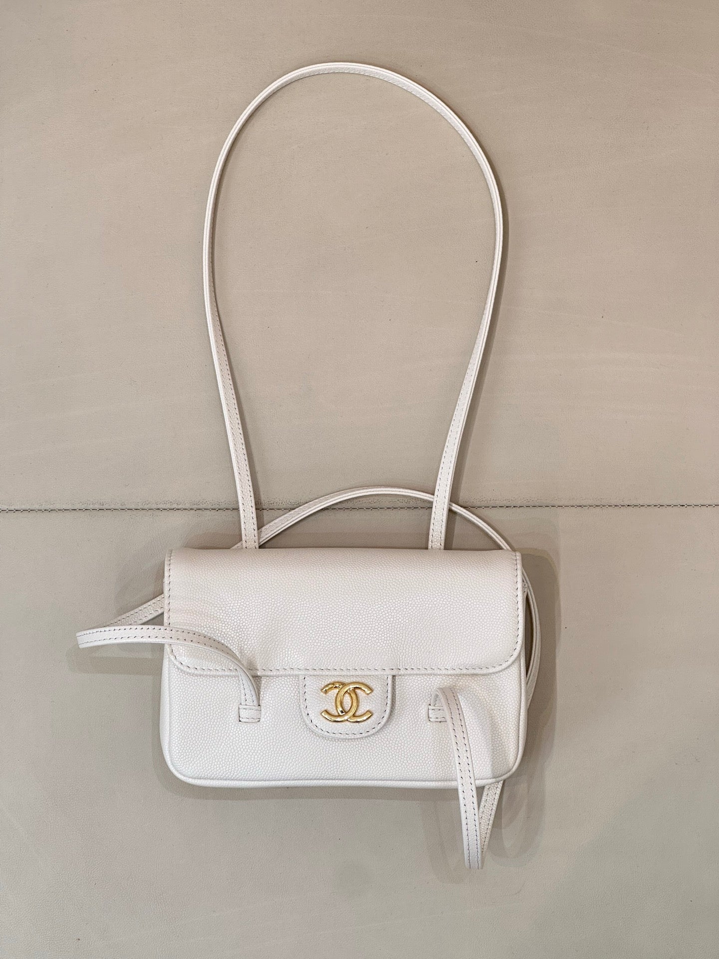 Chanel white leather mini handbag with top flap, CC logo, and loop handles