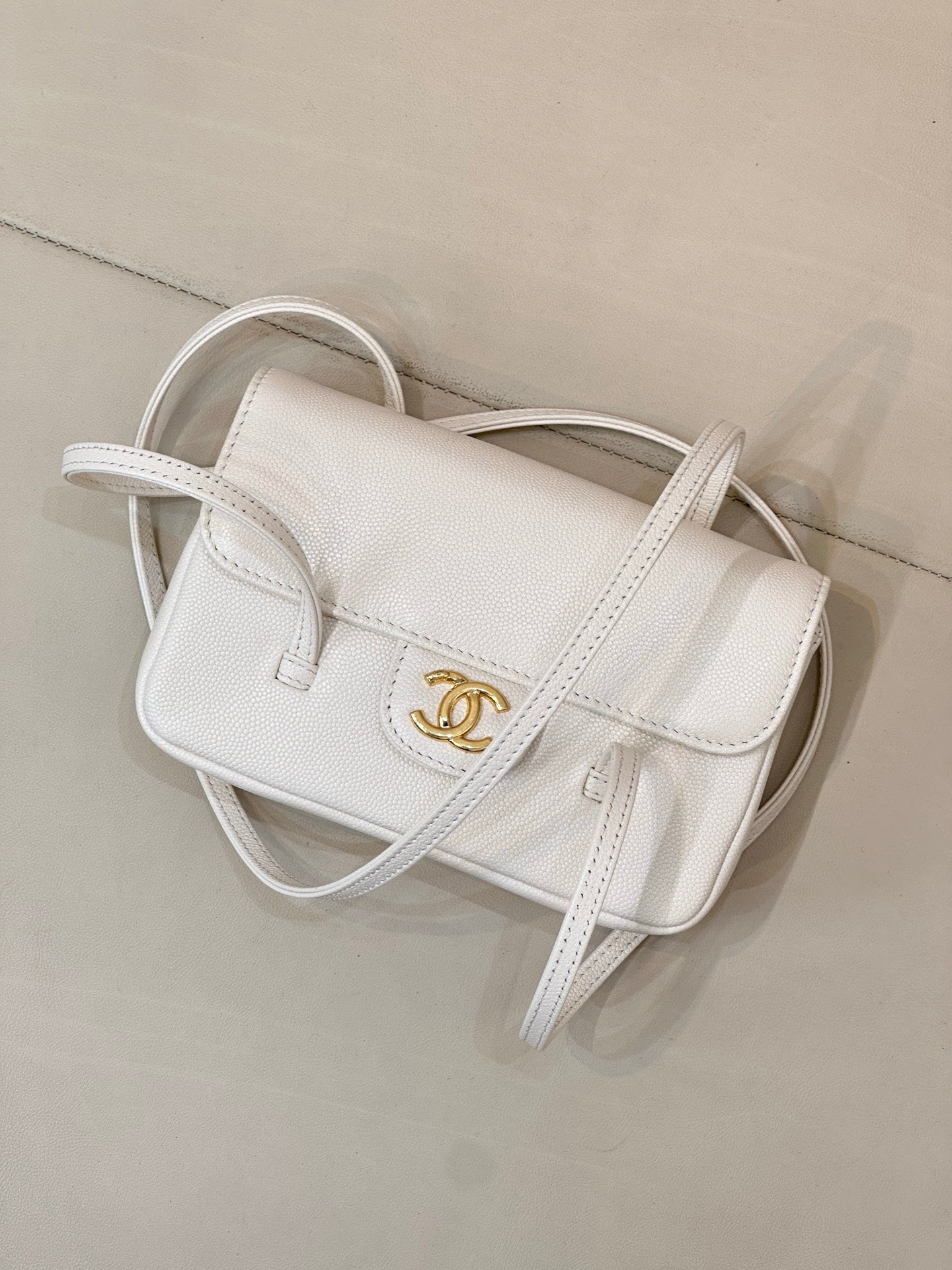 Chanel white leather mini handbag with flap front and CC logo, long handle strap