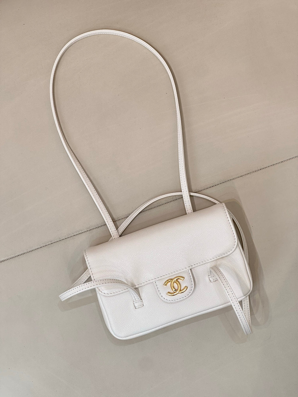 Chanel white leather mini handbag with front flap and CC logo, crossbody straps
