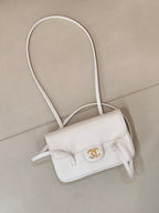 Chanel white leather mini handbag with front flap and CC logo, crossbody straps