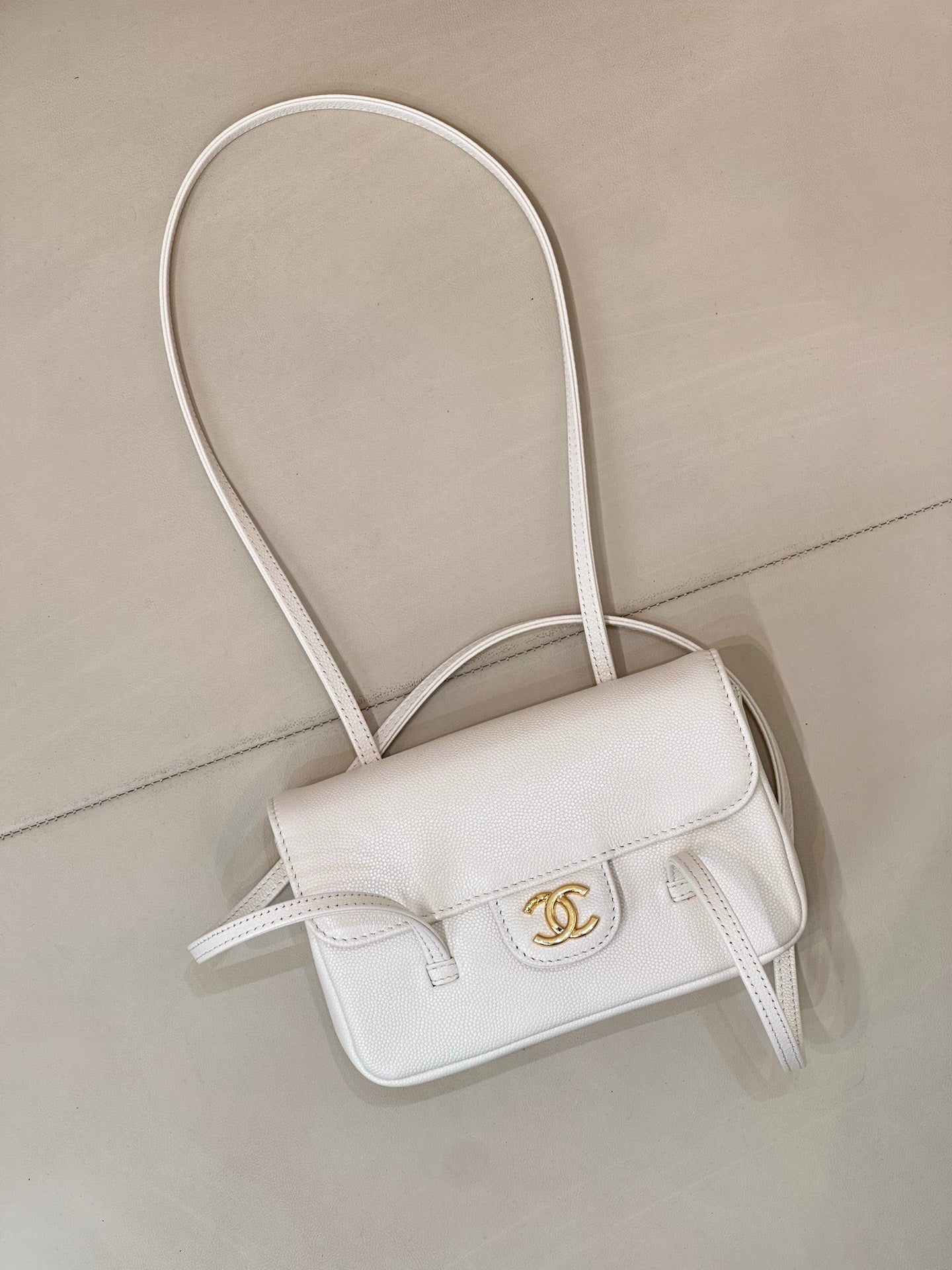Chanel white leather mini handbag with front flap and CC logo, crossbody straps