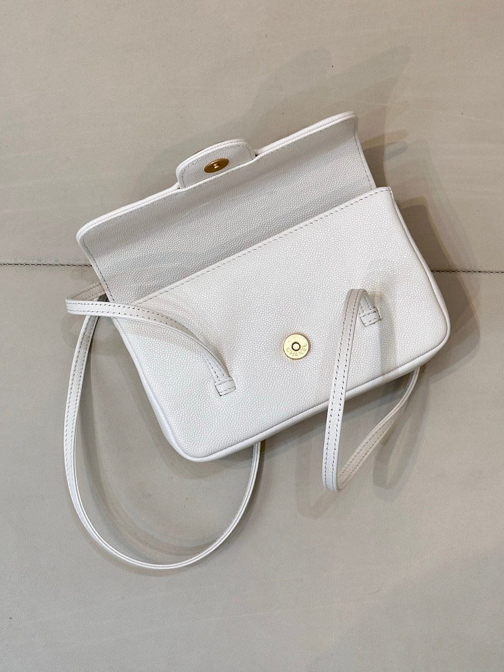 Chanel white leather mini handbag with exterior pocket and gold-tone snap detail