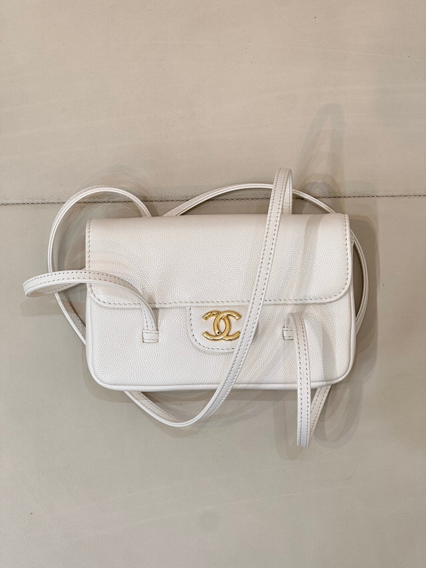 Chanel white leather mini handbag with flap front and CC logo, curved handles