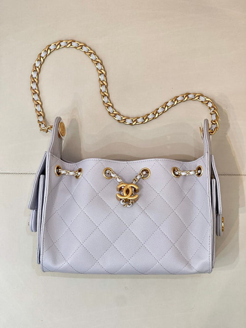 Light blue quilted handbag with gold chain shoulder strap and Chanel logo hardware