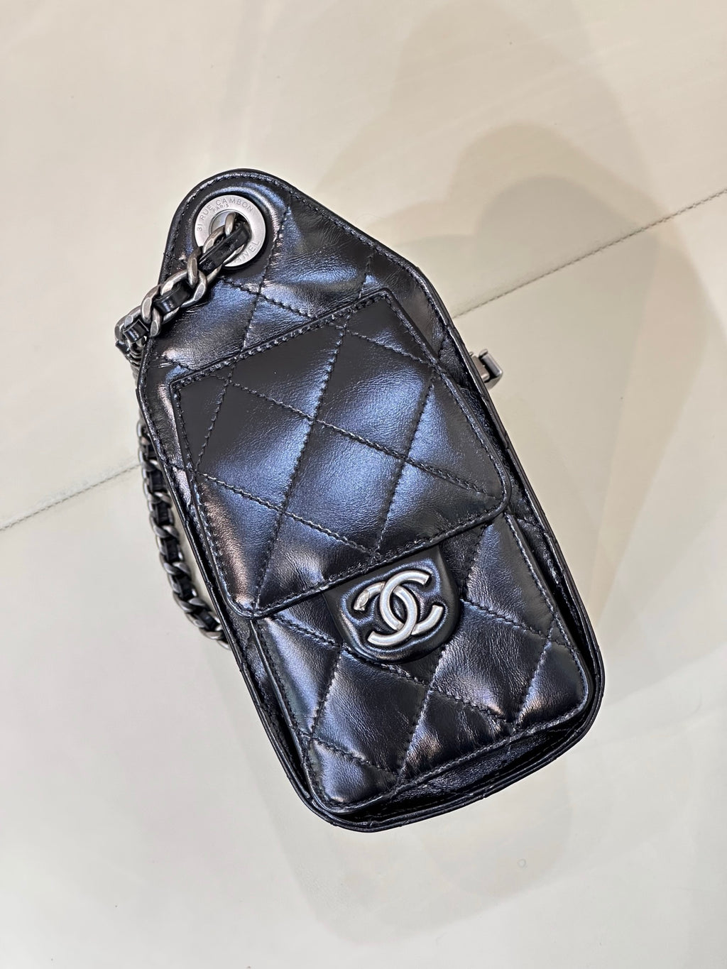 Chanel quilted black mini handbag with flap, chain strap, and CC logo emblem