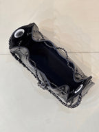 Chanel quilted black handbag top view with chain shoulder strap and metal hardware accents