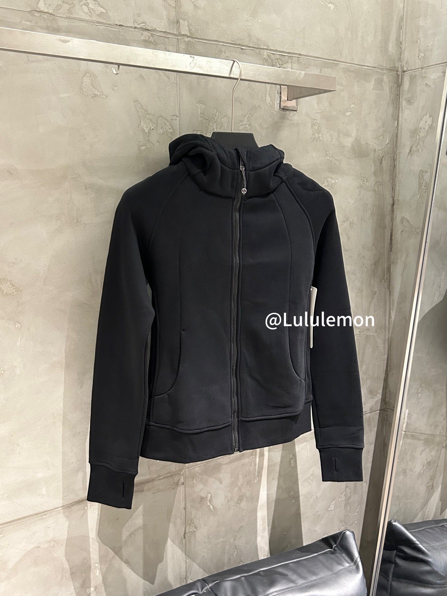 Black zip-up hoodie with hood and kangaroo pocket, front view