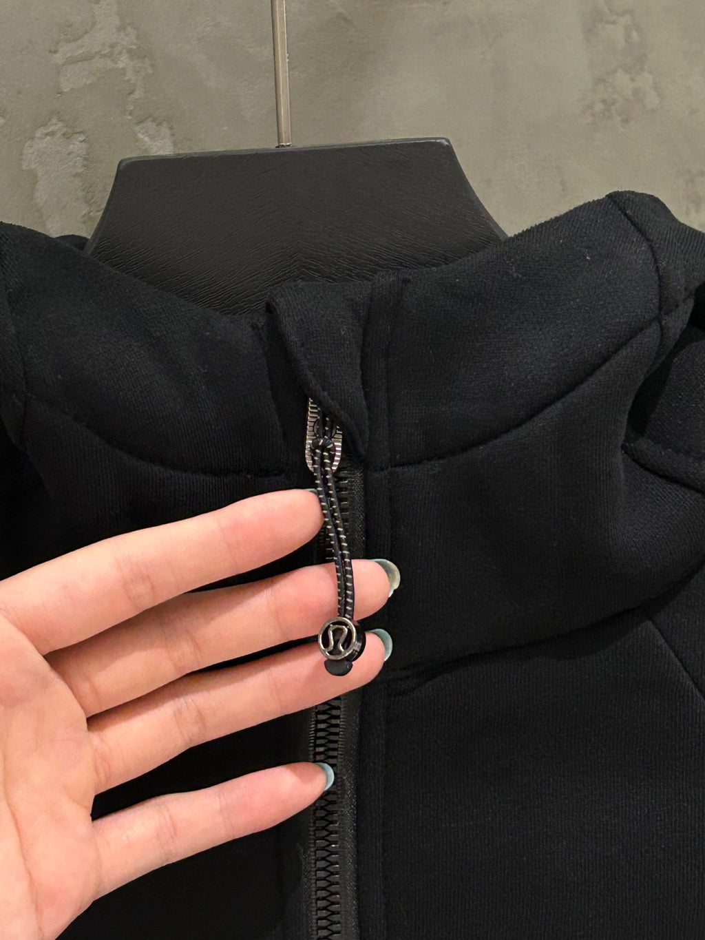 Black hoodie collar and zipper pull detail