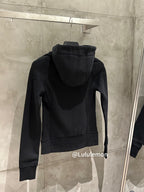Black zip-up hoodie with hood, back view, hanging