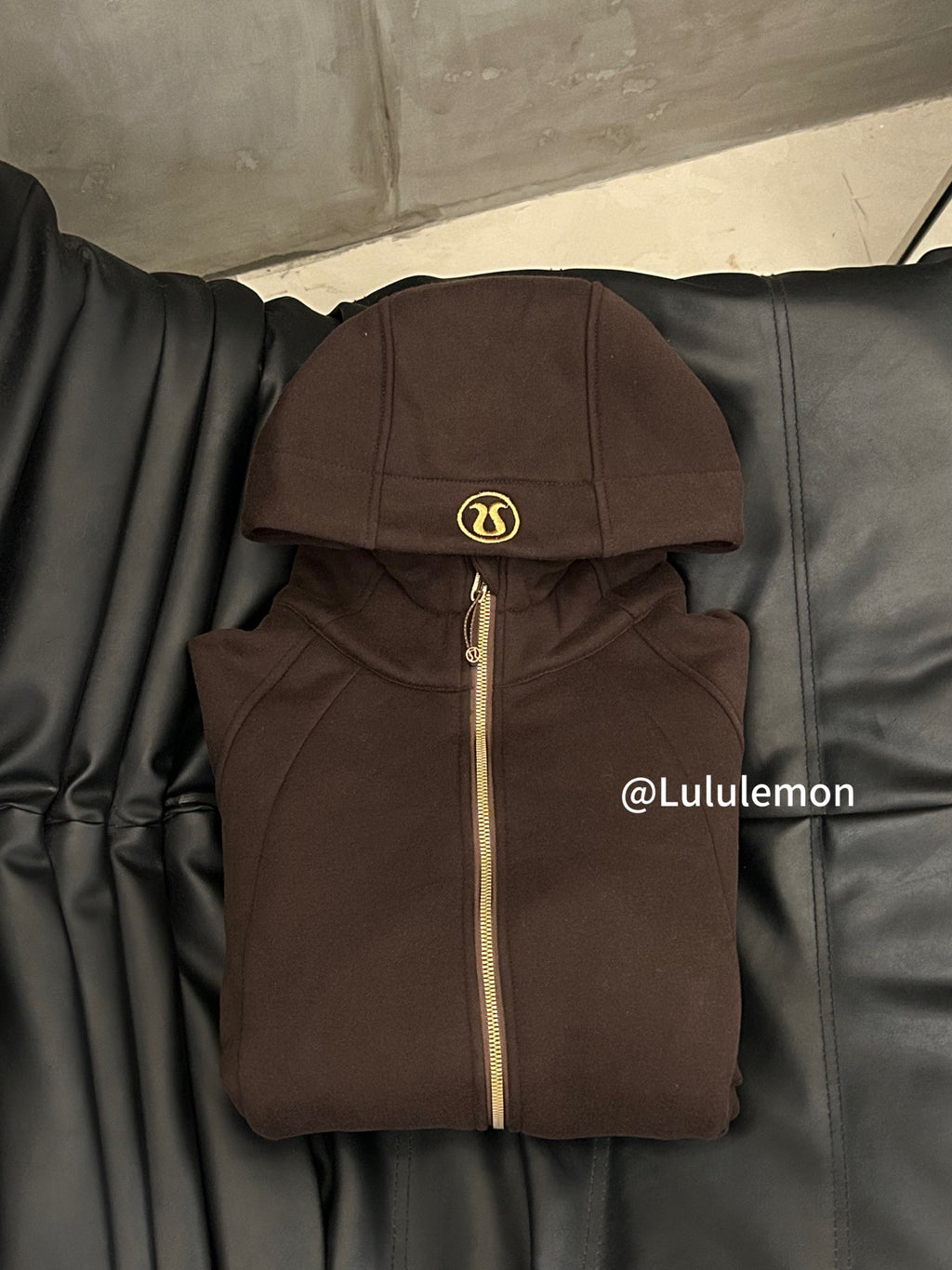 Ralph Lauren brown zip-up hoodie jacket with hood and gold zipper on hanger