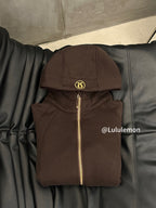 Ralph Lauren brown zip-up hoodie jacket with hood and gold zipper on hanger