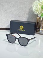 Versace sunglasses with dark lenses and black round frames.