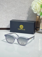 Versace sunglasses with light silver frames and tinted lenses.
