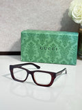 Gucci eyeglasses with dark maroon frames and clear lenses; green logo case.