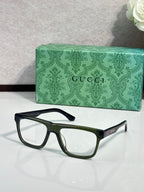Gucci eyeglasses, dark blue frames with green-tinted temple detail