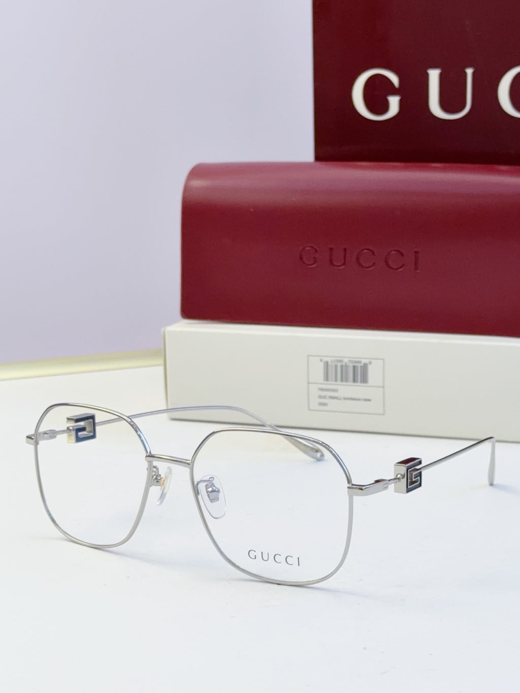 Round metal eyeglasses with dark frame and clear lenses, slim arms