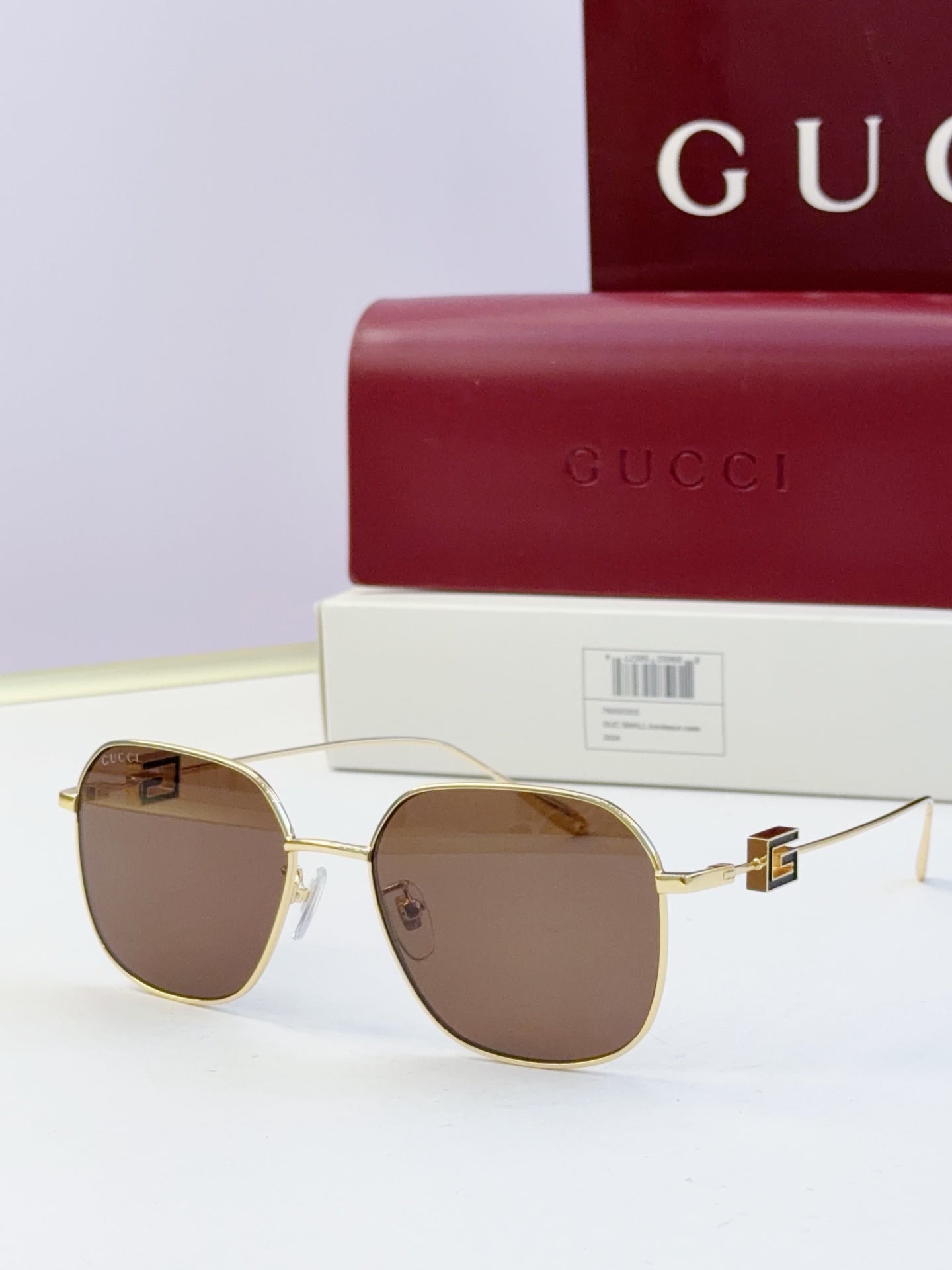 Round metal sunglasses with gold frame and brown tinted lenses