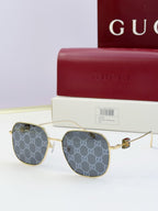 Round metal sunglasses with gold frame and GG-pattern dark lenses