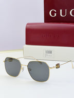 Round metal sunglasses with gold frame and dark gray-blue lenses