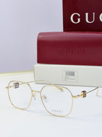 Round metal eyeglasses with gold frame and clear lenses