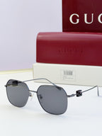 Round metal sunglasses with dark lenses and black temples