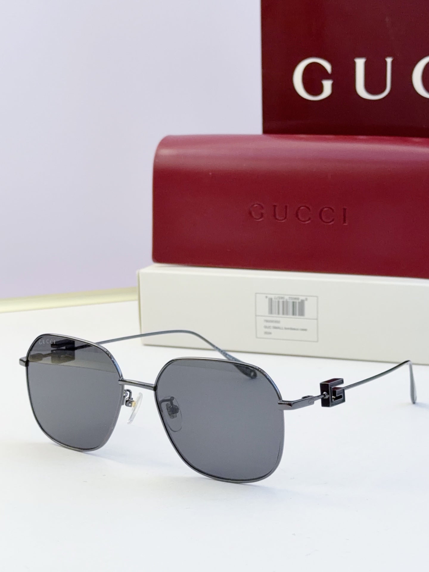 Round metal sunglasses with dark lenses and black temples