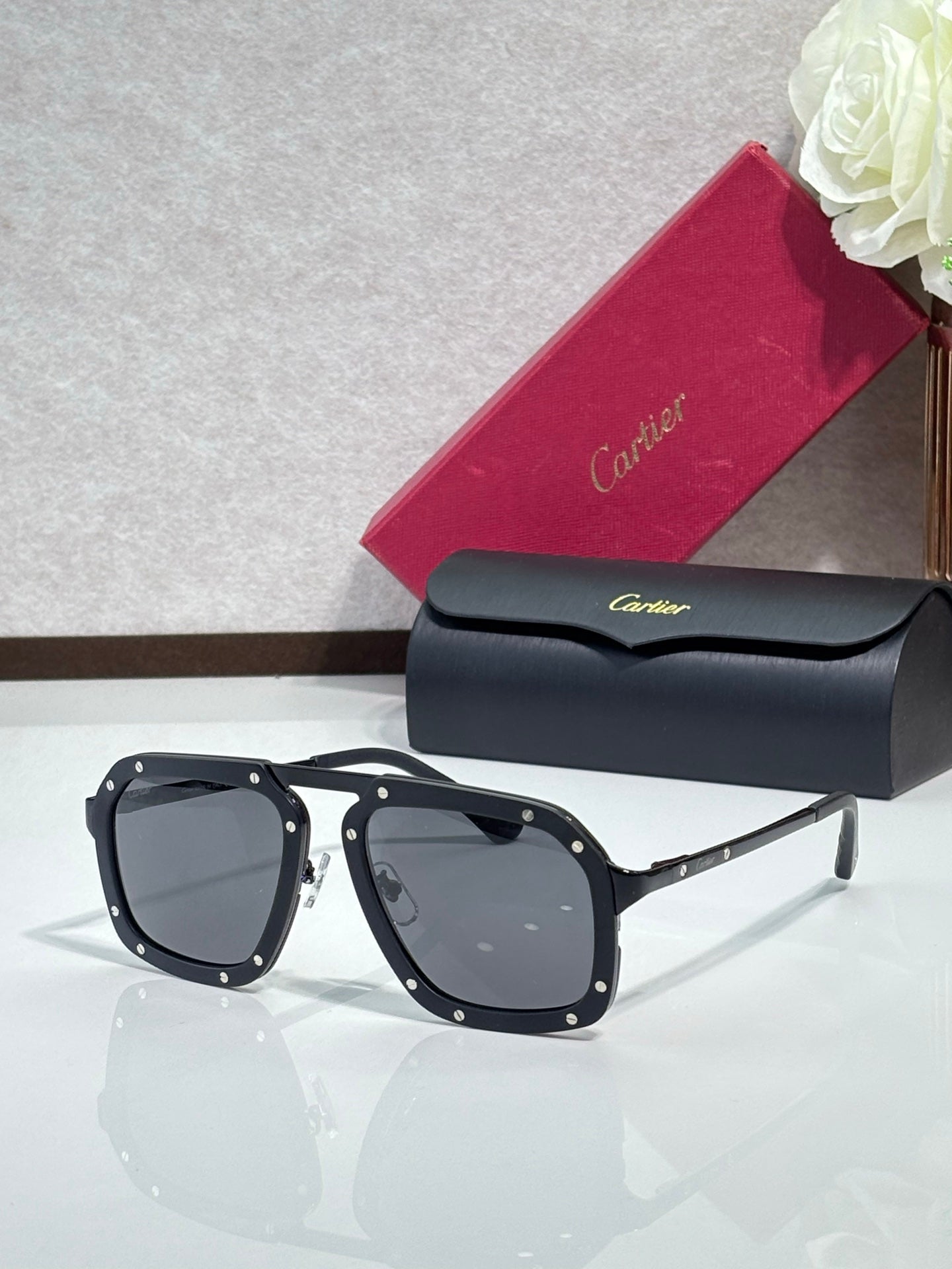 Square black acetate sunglasses with dark gray lenses, slim gold-tone temples