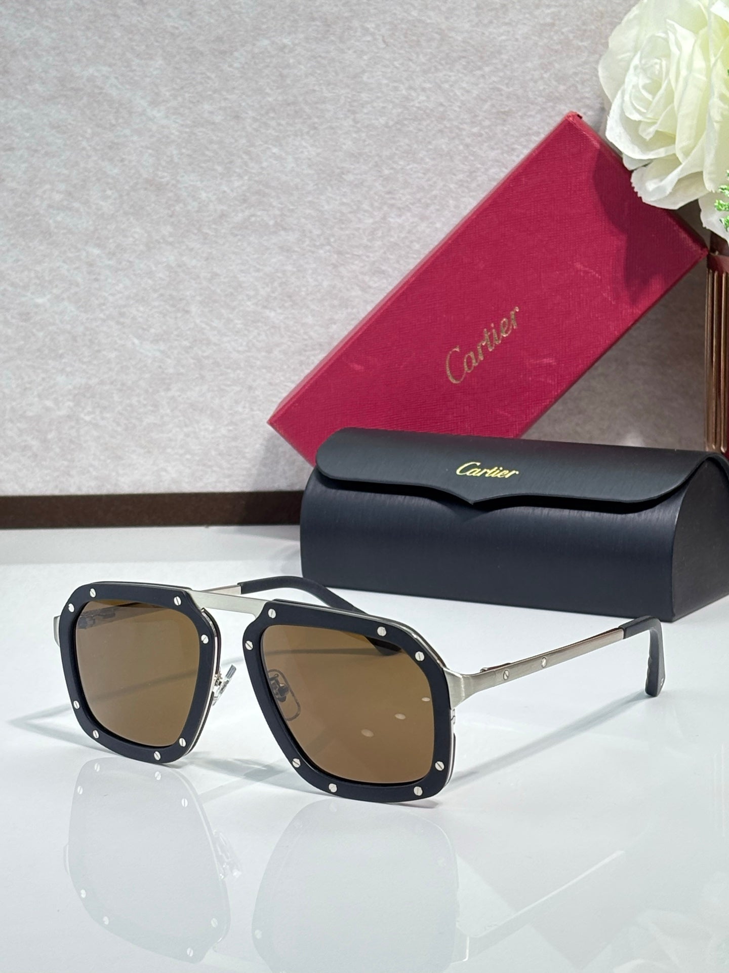 Square black acetate sunglasses with brown-tinted lenses, gold-tone temples