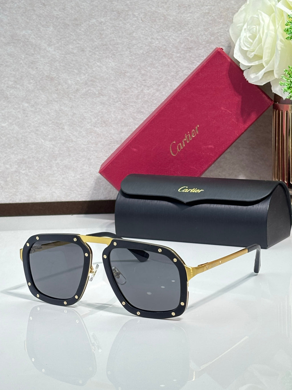 Square black acetate sunglasses with dark gray lenses, gold-tone temples