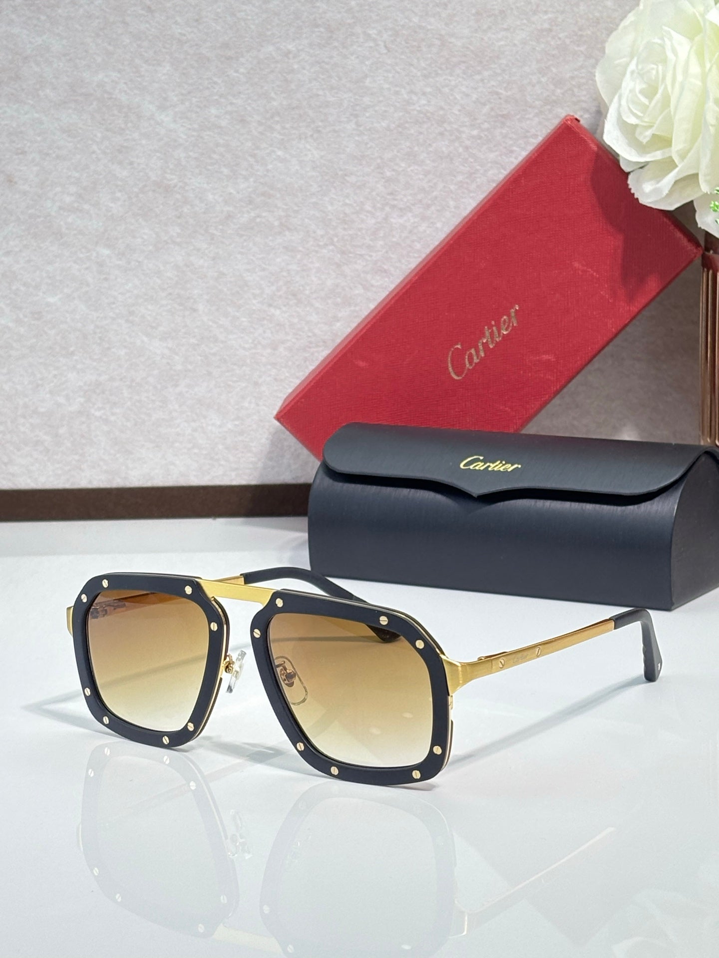 Square black acetate sunglasses with brown-tinted lenses, gold-tone temples