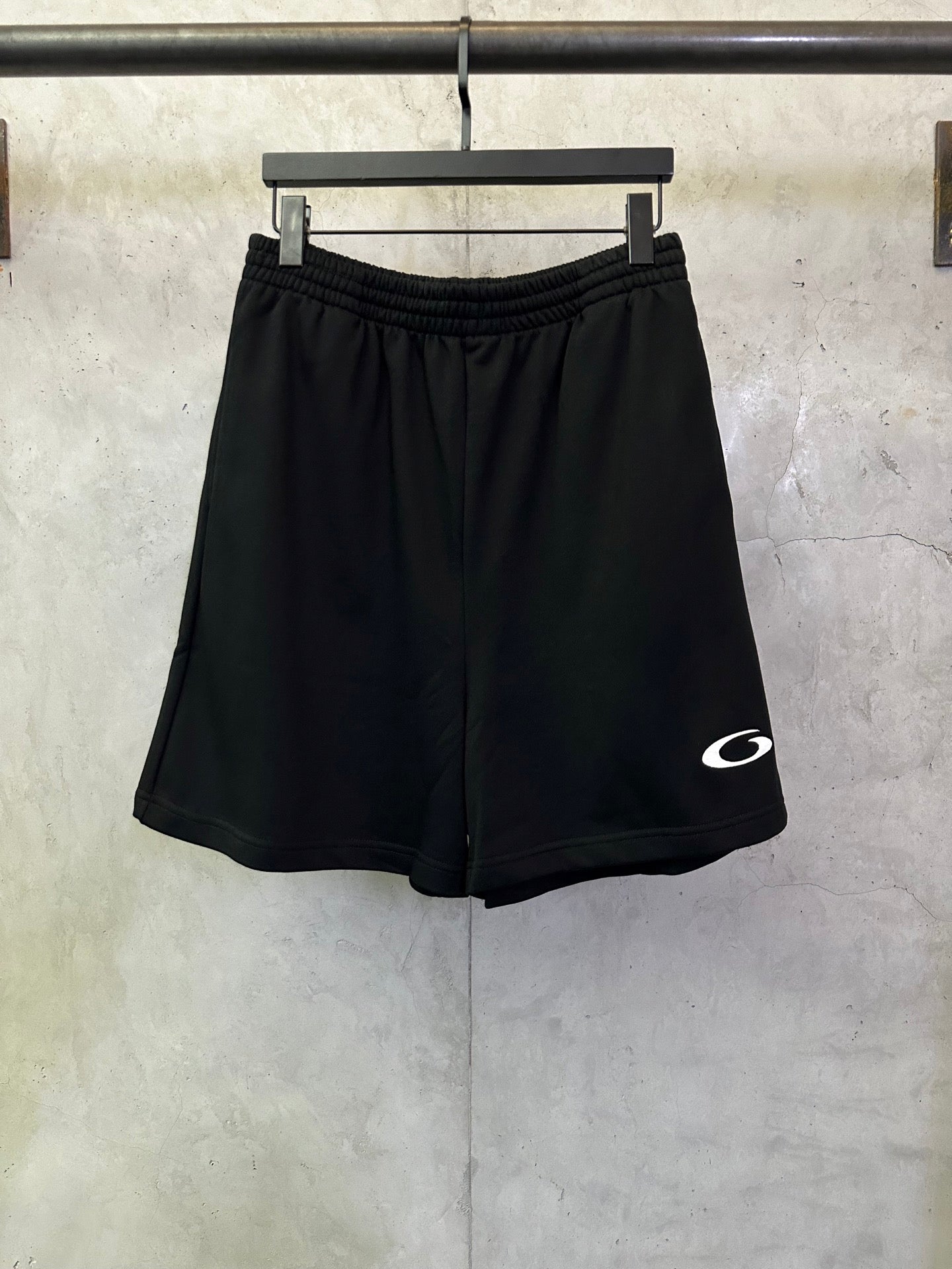 Balenciaga shorts in dark black with elastic waistband and small white logo on side