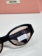 Black cat-eye sunglasses close-up of temple and lens markings