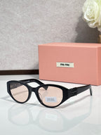 Black cat-eye sunglasses with dark lenses and gold-tone temple detailing