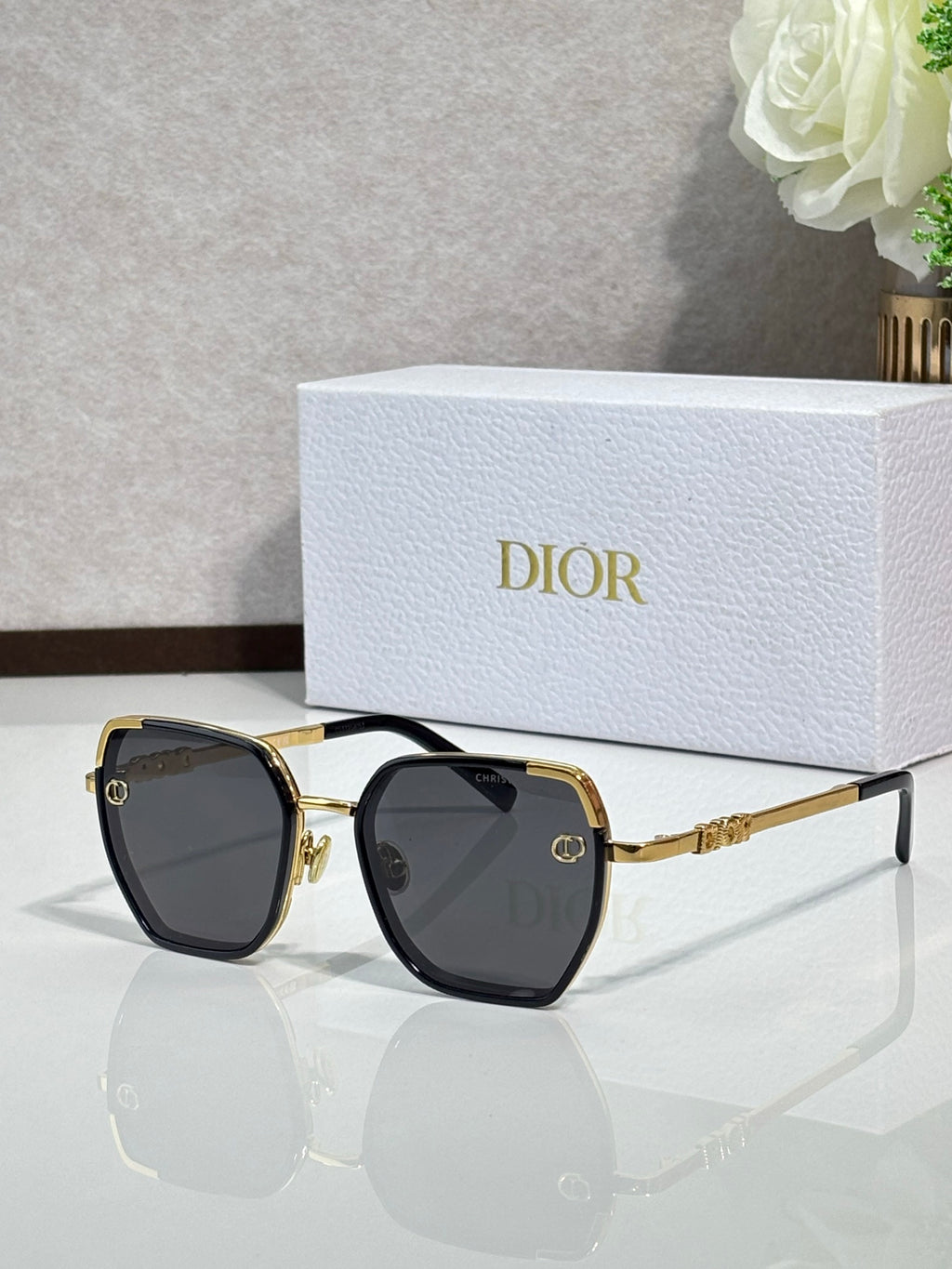 Dior sunglasses with dark lenses and gold-tone oversized square frames